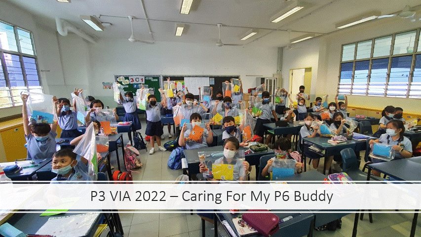 Students in masks hold up colorful gift bags in a classroom, captioned "P3 VIA 2022 – Caring For My P6 Buddy."